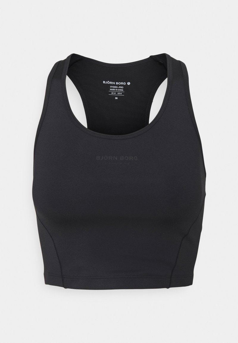Brassière de sport noire à coupe ajustée, confectionnée dans un tissu lisse et extensible. Présente un style dos nageur et un logo discret imprimé sur le devant.