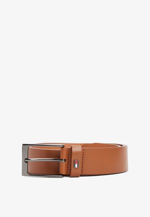 Brown leather belt with a smooth texture, silver metal buckle, and a small logo accent in red, white, and blue near the buckle.
