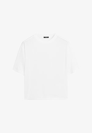 White cropped t-shirt made from soft cotton. Features a round neckline and short sleeves with a relaxed fit, minimalistic design.