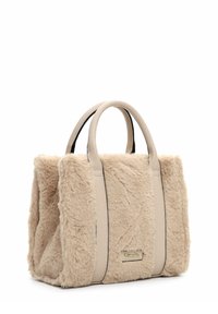 Beige faux fur handbag with structured design, leather accents, dual handles, and a gold logo tag. Soft texture with a rectangular shape.