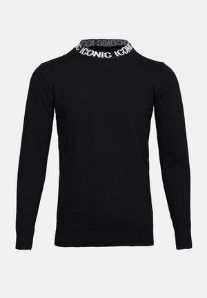 Fekete pulóver bordázott nyakkivágással, fehér "ICONIC" felirattal, hosszú ujjakkal és sima textúrájú testtel.