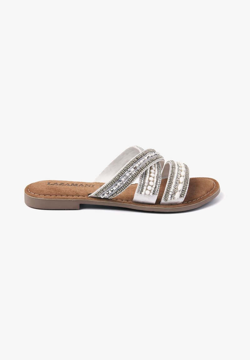 Flat slide sandal with three metallic straps, detailed with beads and sequins. Brown faux suede footbed and light-colored outsole.