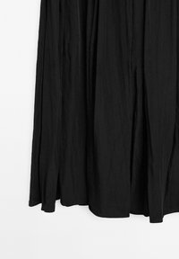 Black maxi dress with a flowing silhouette, made from lightweight fabric. Notable vertical pleats create texture and movement.