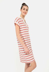 Gestreiftes Kleid in Creme- und Koralltönen, mit kurzen Ärmeln, lockerem Schnitt und V-Ausschnitt. Weiches Baumwollmaterial mit einem seitlichen Schlitz.