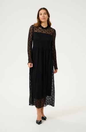 Black lace dress with long sleeves, a fitted bodice, and flowing skirt. Features intricate floral patterns and a modest neckline.
