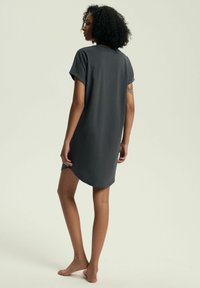 Szara sukienka do kolan z krótkimi, podwiniętymi rękawami. Miękka, lekka tkanina z lekkim połyskiem. Zaokrąglony dół i luźny krój.