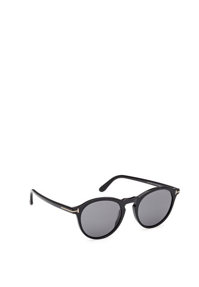 Ochelari de soare rotunzi negri cu lentile gri, având un accent subțire de aur pe ramă, construși dintr-un plastic elegant și având brațe curbate.