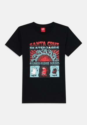 Black cotton t-shirt featuring a colorful graphic print of screaming faces and the text "Santa Cruz Skateboards" in red and blue.