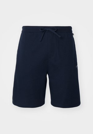 Marineblaue Shorts aus einem weichen, strukturierten Stoff mit elastischem Bund und seitlichen Taschen, versehen mit einem dezenten Logo am Bein.