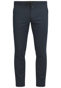 Navy blue tapered pants made of textured fabric. Features an adjustable drawstring waistband and side pockets. Smooth finish, slim fit.