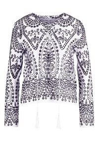 Langærmet hvid top med indviklet sort broderi, der har mønstre af cirkler og blomsterdesigns, afsluttet med frynsetrabatter ved kanten.