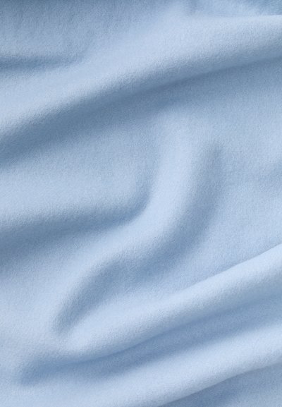 Lys blå stof med en glat, blød tekstur, der viser subtile farvevariationer og bløde folder gennem det meste.