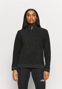 Sort fleece pullover med halv-zipped krave, struktureret overflade, ribbede manchetter og nederste kant, med et logo på den nedre front venstre.
