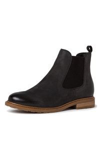 Stivale alla caviglia in pelle nera con pannelli elastici laterali, un tacco texture e una suola in gomma marrone. Dotato di una linguetta sul retro per una facile calzata.