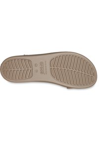 Beige Crocs-zool met een gestructureerd profiel voor grip. Inclusief reliëf logo-details en een gladde afwerking.