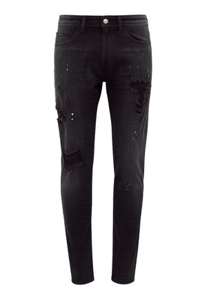 Sorte denim skinny jeans med slidte detaljer, der har revner og grønne sprøjt accenter over hele. Klassisk fem-lomme design.