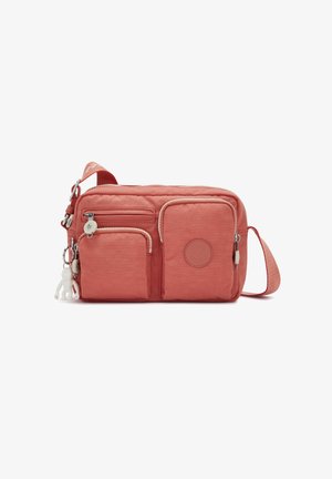 Coral nylon crossbody bag with multiple zippered pockets, a soft texture, and a fabric strap. Features a round logo and a white charm.