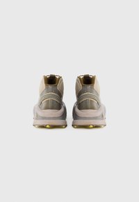 Sleek, high-top sneakers in beige and gray with a textured finish, featuring a rubber sole with yellow accents and pull tabs.