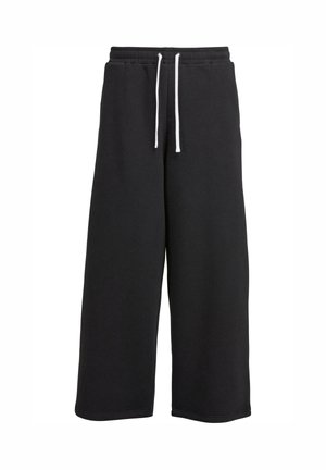 Zwarte wijde sweatpants gemaakt van zachte stof, met een elastische tailleband en witte trektouwen, en een eenvoudige uitstraling.