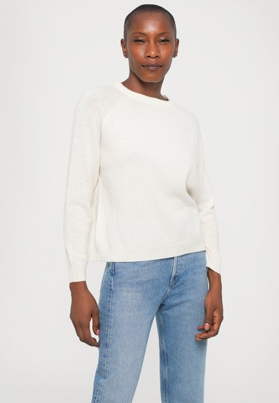 Cream-colored, lightweight sweater with a round neckline and long sleeves. Features ribbed cuffs and a relaxed fit. Pair with light blue jeans.