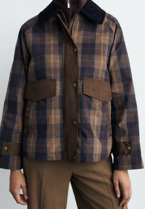Brown and navy plaid jacket with dark brown collar, buttoned cuffs, front pockets, and a zipper closure over a brown zip-up top.