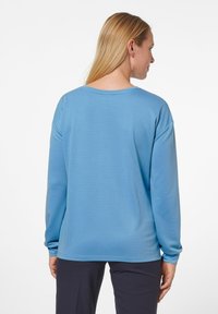 Helles blaues Langarmshirt mit Rundhalsausschnitt und lockerer Passform. Hergestellt aus glattem Stoff mit geradem Saum.