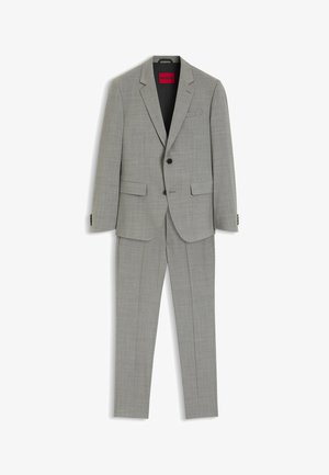 Traje de dos piezas color gris claro con blazer de solapa con muesca, dos bolsillos delanteros con solapa, botones negros y pantalones a medida a juego.