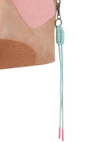 Tasche aus braunem Leder mit gepunkteten Applikationen in Pink und Braun. Sie verfügt über einen hellblauen Kordelhenkel und eine Quaste mit pinken Enden.