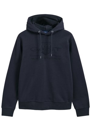 Hoodie bleu marine en tissu doux, avec un logo en relief de la même couleur à l'avant, une capuche avec cordon de serrage et des poignets côtelés.