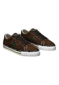 Brown suede sneakers with black laces and white rubber soles. Features a green star accent and "4 LEAF CLOVER" branding along the sole.