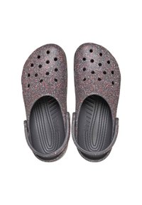 Black and red speckled clogs with ventilation holes and back strap; made of lightweight material with textured footbed and smooth interior.