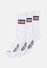 Hvid bomuldsblandingsstrømper med ribbet tekstur. Har sort og rød Levi's logo og tekst på siden. Tre par inkluderet.