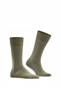 Chaussettes en coton vert olive avec un bord côtelé, longueur mi-mollet, texture lisse, et zones renforcées aux orteils et au talon.