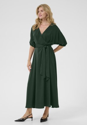 Dark green, floor-length wrap dress with short puff sleeves, a V-neckline, and a tied waist. Smooth fabric, minimalistic design.
