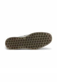 Sål med en tekstureret gummioverflade, der har cirkulære grebmønstre. Farven er lys brun med en glat beige kant.