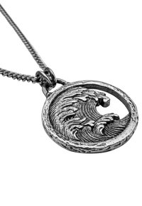 Silver pendant featuring an intricate wave design within a circular frame, hung on a textured chain. Distinctive detailing and finish.