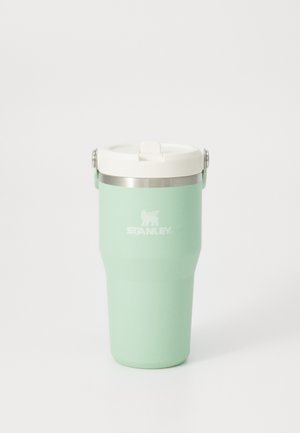 Mint green Stanley insulated travel mug with white lid and silver handle, set against a plain white background.
