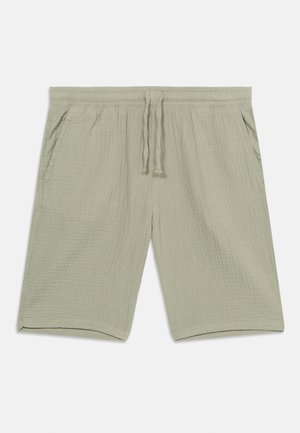 Heledat beeži tekstuuriga lühikesed püksid, millel on elastne vöökoht, pael ja küljetaskud, paigutatud lamedalt valgele taustale.