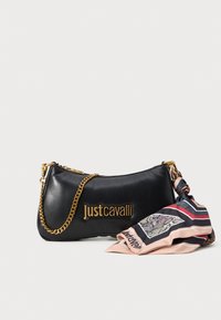 Black leather handbag with a gold chain strap, featuring a logo and a patterned silk scarf attached at the side, in contrasting colors.