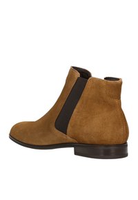Brauner Wildleder-Stiefeletten mit elastischen seitlichen Einsätzen, runder Zehenpartie, flachem Absatz und glatter Textur. Minimalistisches Design mit klaren Linien.