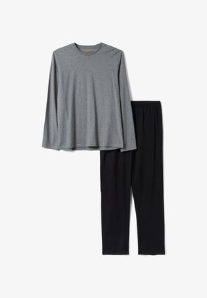 Chemise grise à manches longues associée à un pantalon noir à taille élastique, présentée à plat sur un fond blanc.