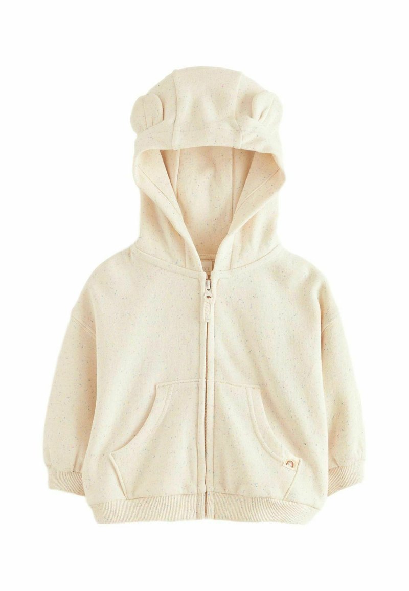 Haut à capuche beige zippé avec des oreilles d'ours sur la capuche, deux poches avant et une texture marbrée. Tissu doux avec des poignets et un ourlet côtelés.