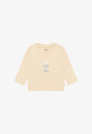 Camicia beige chiaro a maniche lunghe in morbido cotone, con una stampa grafica con la scritta "SEA YOU" e un piccolo disegno di pesce sotto.