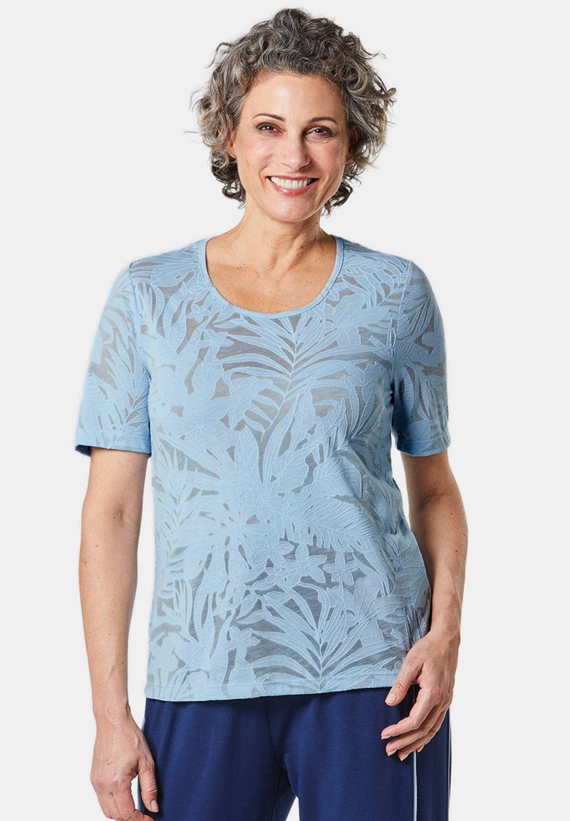 T-shirt bleu clair à manches courtes avec un motif de feuilles texturé, col rond et coupe décontractée. Fabriqué à partir d'un tissu doux et respirant.