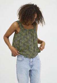 Ärmvärmare med blommönster och fyrkantig halsringning, tillverkad av lätt tyg i svarta, gula och gröna nyanser. Avslappnad passform.