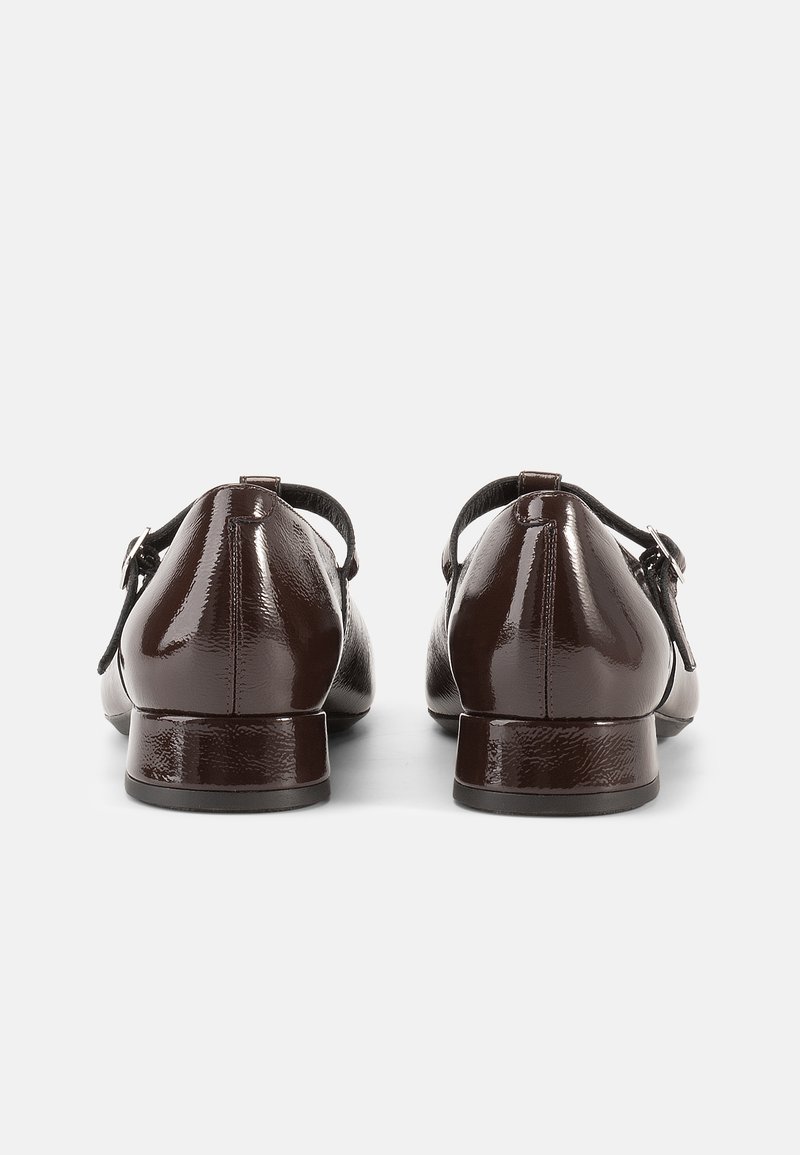 Brown patent leather shoes with a rounded toe, low heel, ankle strap, and buckle detail. Smooth, glossy texture with minimal accents.
