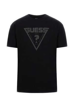 Sort bomulds t-shirt med et stort trekantet logo med "GUESS" og "NINETEEN EIGHTY-ONE" i mat finish centreret på fronten.