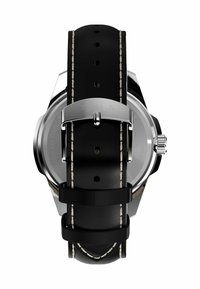 Náramkové hodinky Timex s černým koženým páskem s bílým šitím, pouzdrem z nerezové oceli a kulatým kovovým dnem.