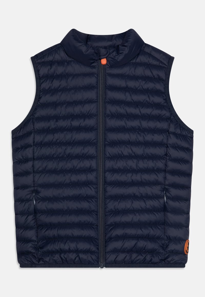 Tumesinine tikitud ilma varrukateta vest ees luku ja kõrge kaelusega, millel on väike oranž nupp ja logo patch allservas.