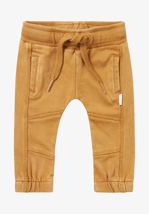 Dziecięce spodnie dresowe w kolorze musztardowej żółci, z elastycznym paskiem w talii, sznurkiem do regulacji, bocznymi kieszeniami oraz przeszyciami na kolanach.
